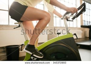 stock-photo-cropped-shot-of-fitness-woman-working-out-on-exercise-bike-at-the-gym-female-exercising-on-bicycle-345372893